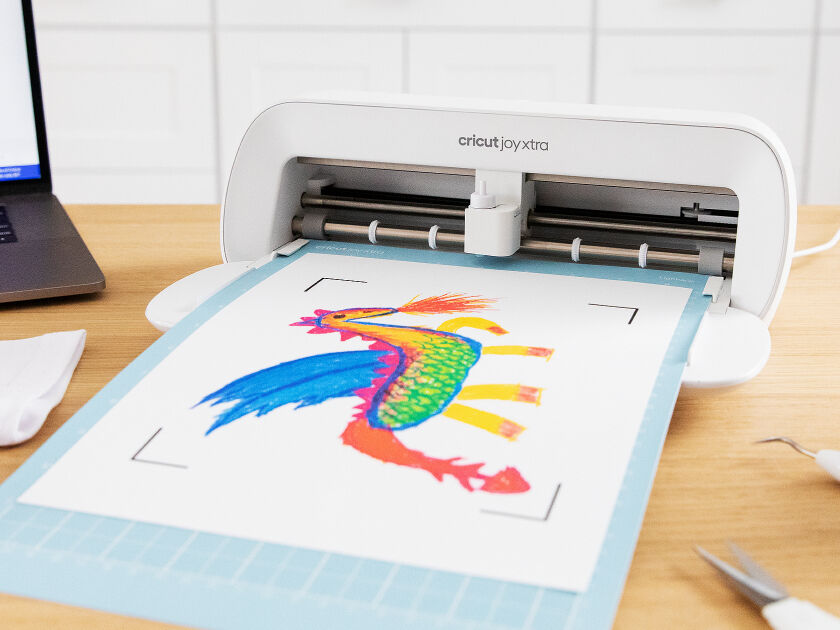 Cricut Explore 3 smart cutting machine cutting blue vinyl